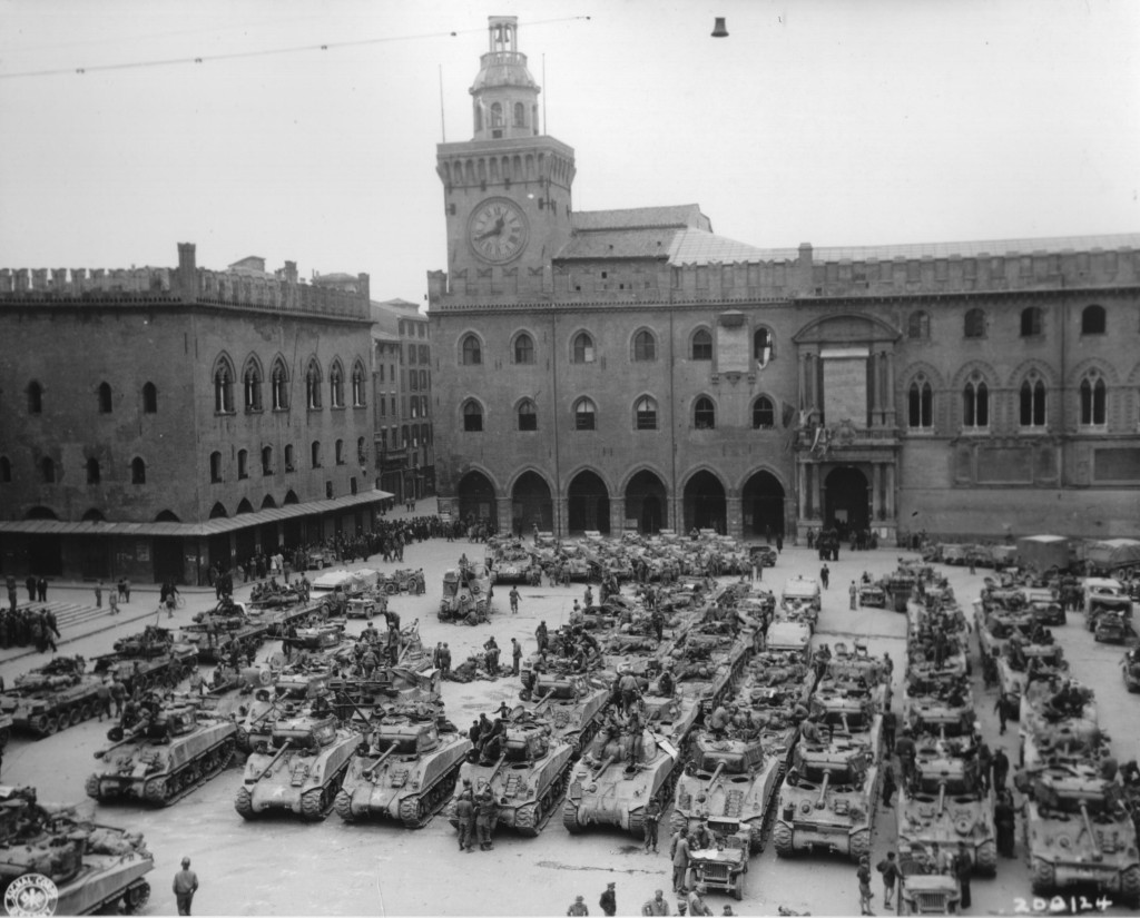A whole tank company or more parked in a square.