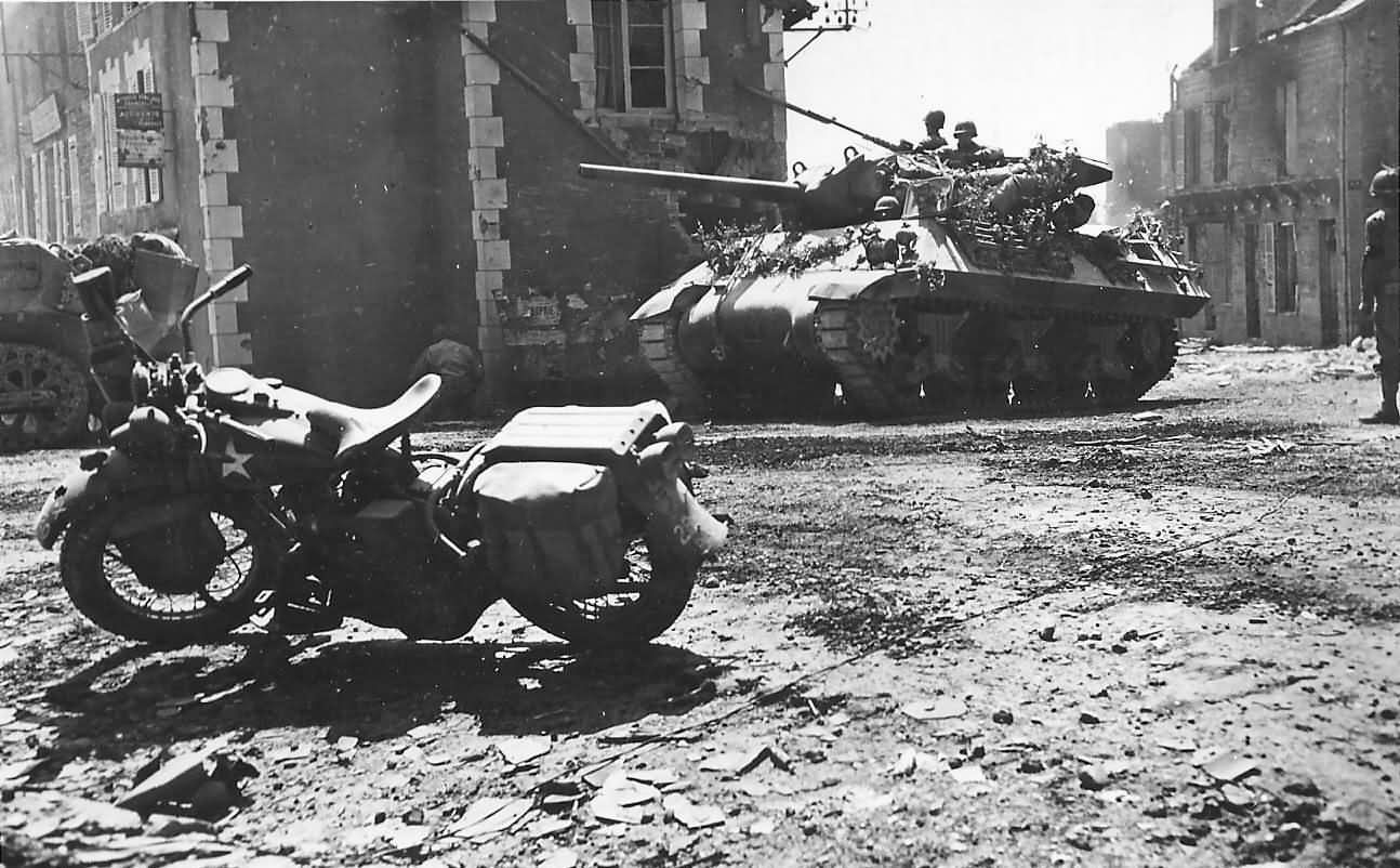 Camouflaged_M10_Tank_Destroyer_And_Harley_Davidson_In_Percy_France_08_1944